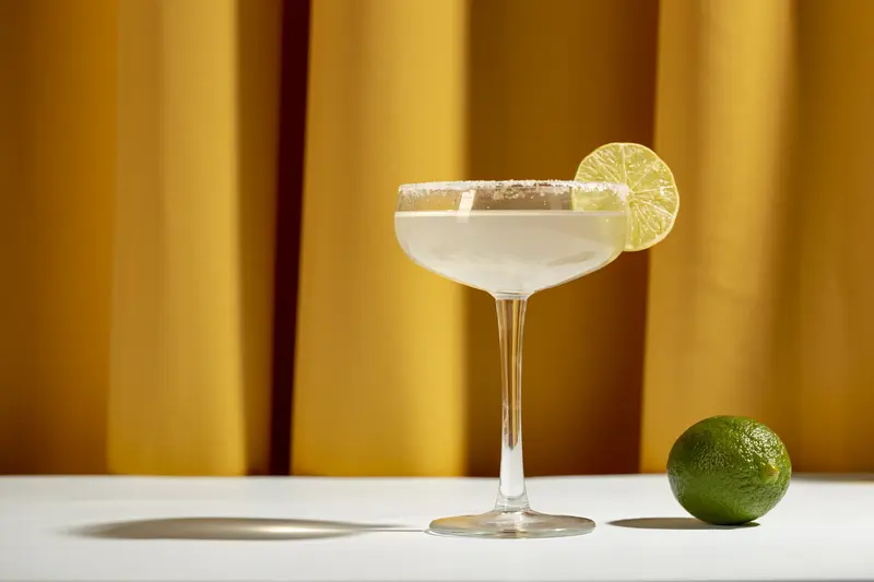 lemon margarita cocktail with salted rim and lime garnish