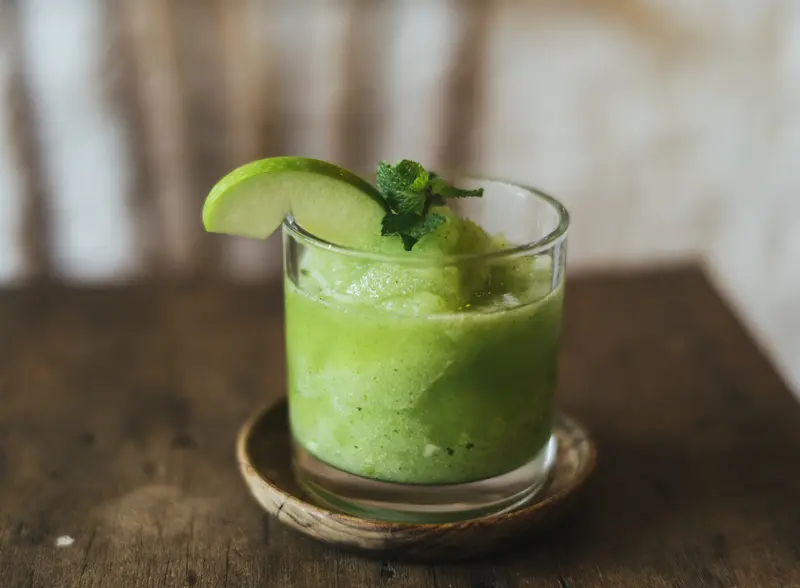 avocado margarita with smooth green texture avocado margarita style cocktail with green texture and fresh fruit garnish